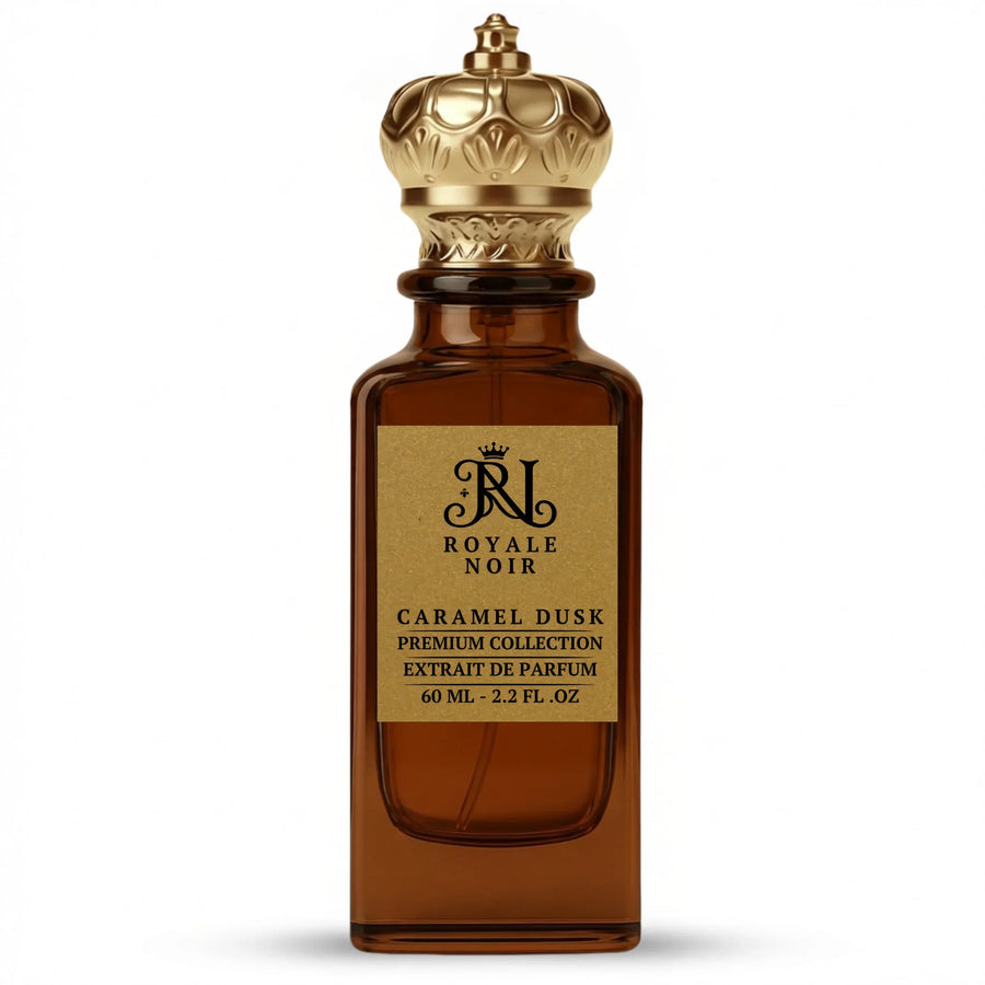 Caramel Dusk Extrait De Parfum Premium Collection by Royale Noir – Elegant Fragrance in Transparent Brown Bottle With Gold Label And Gold Crown Cap.