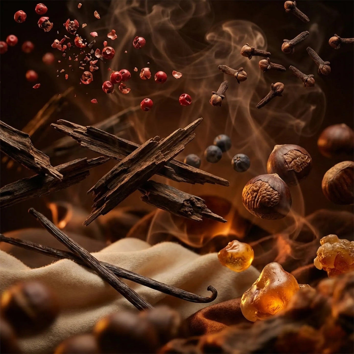 Royale Noir "Freaking Hot" Perfume Ingredients containing Spices and herbs including cinnamon sticks, woods, cloves, and vanilla beans with smoke in the background.